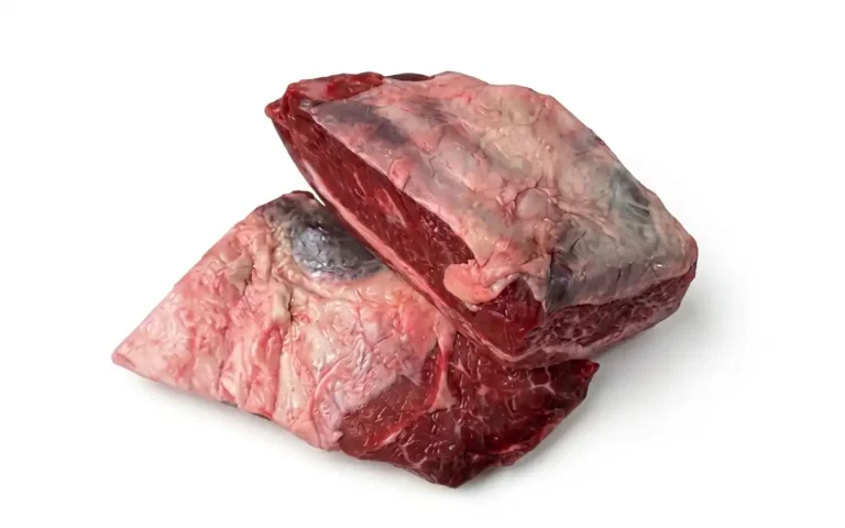 Rauwe runder short ribs van Erfgoed Bossem met bot en vetmarmering op een witte achtergrond.